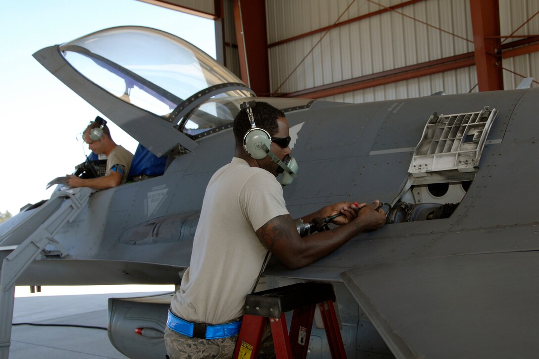 Senior Master Sgt. Brian Norris, a weapons inspector assigned to AFNORTH/1AF from Tyndall Air Force Base, Fla., evaluates a 169th Fighter Wing's weapons load team during a weapons reliability check, Sept. 26, 2012.  The McEntire team consists of Master Sgt. Jeremy Pow (left), team leader, and Senior Airmen Steven Hollis and Carlos Graham (right), all assigned to the 169th Fighter Wing's Aerospace Control Alert unit.  McEntire Joint National Guard Base's Aerospace Control Alert mission receives an Alert Force Operational Assessment (AFOA) inspection from 1AF/AFNORTH to evaluate its ability to provide for our nation's homeland defense.  McEntire is home of the Swamp Foxes of the South Carolina Air National Guard and the 169th Fighter Wing.