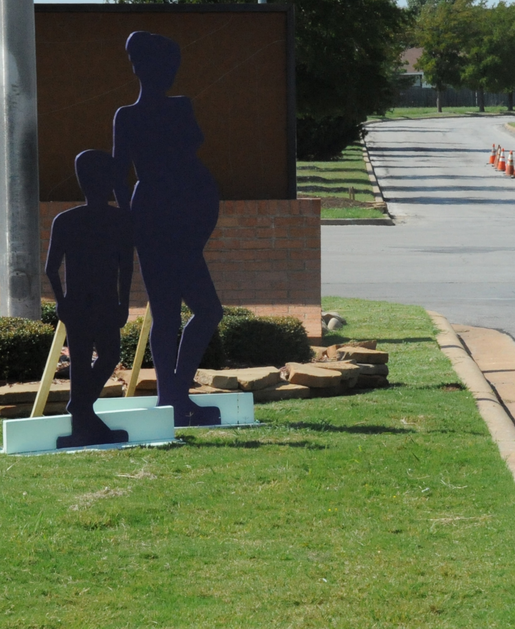 Throughout Oct. a silent witness display of silhouettes of an adult female and male, a pregnant woman, young girl and boy, and an infant will be posted at both the main gate and Missile road gate to represent all of people affected by domestic violence and to honor those who have lost their life due to domestic violence. (U.S. Air Force Photo/Kimberly Dagdag)