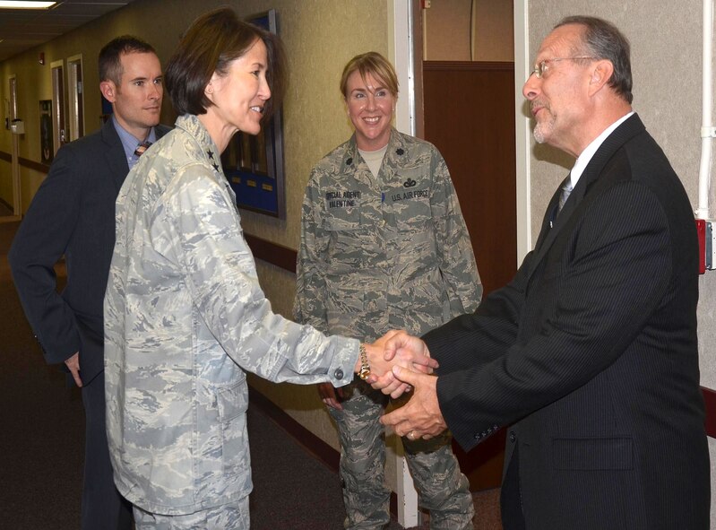 Maj. Gen. Sharon K.G. Dunbar, Air Force District of Washington commander, Joint Base Andrews, Md., shakes hands with Special Agent James "Smitty" Smith. Dunbar paid a special visit to the Air Force Office of Special Investigations 7th Field Investigations Squadron and 2nd Field Investigations Squadron at JB Andrews October 5. Also pictured is Lt. Col. Tara Valentine, center, and Special Agent Sam Brandt, left. (U.S. Air Force Photo.)