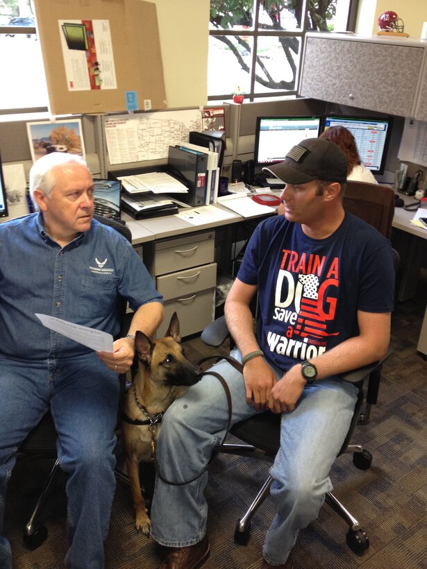 Staff Sgt. Andrew Goligowski (right), an Air Force wounded warrior, meets with Charlie O’Connor, his nonmedical care manager. Watching patiently is Mali, Goligowski’s service dog. Goligowski received Mali through the Train A Dog – Save A Warrior program. (U.S. Air Force photo/Scott Hand) 