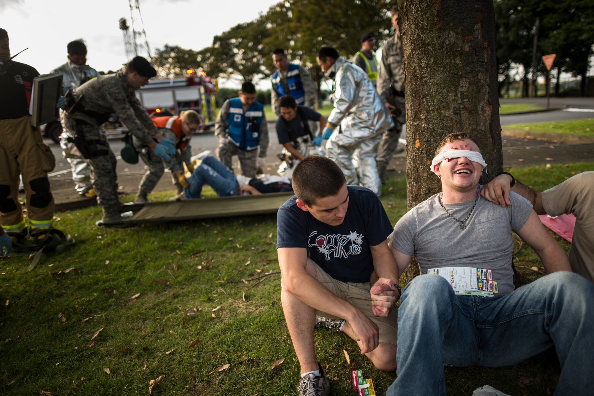 YOKOTA AIR BASE, Japan -- Bystanders comfort a simulated victim during an emergency management exercise at Yokota Air Base, Japan, Oct. 5, 2012. Role players stayed in character throughout the exercise to help responders practice triage and patient management. (U.S. Air Force photo by Tech. Sgt. Samuel Morse)