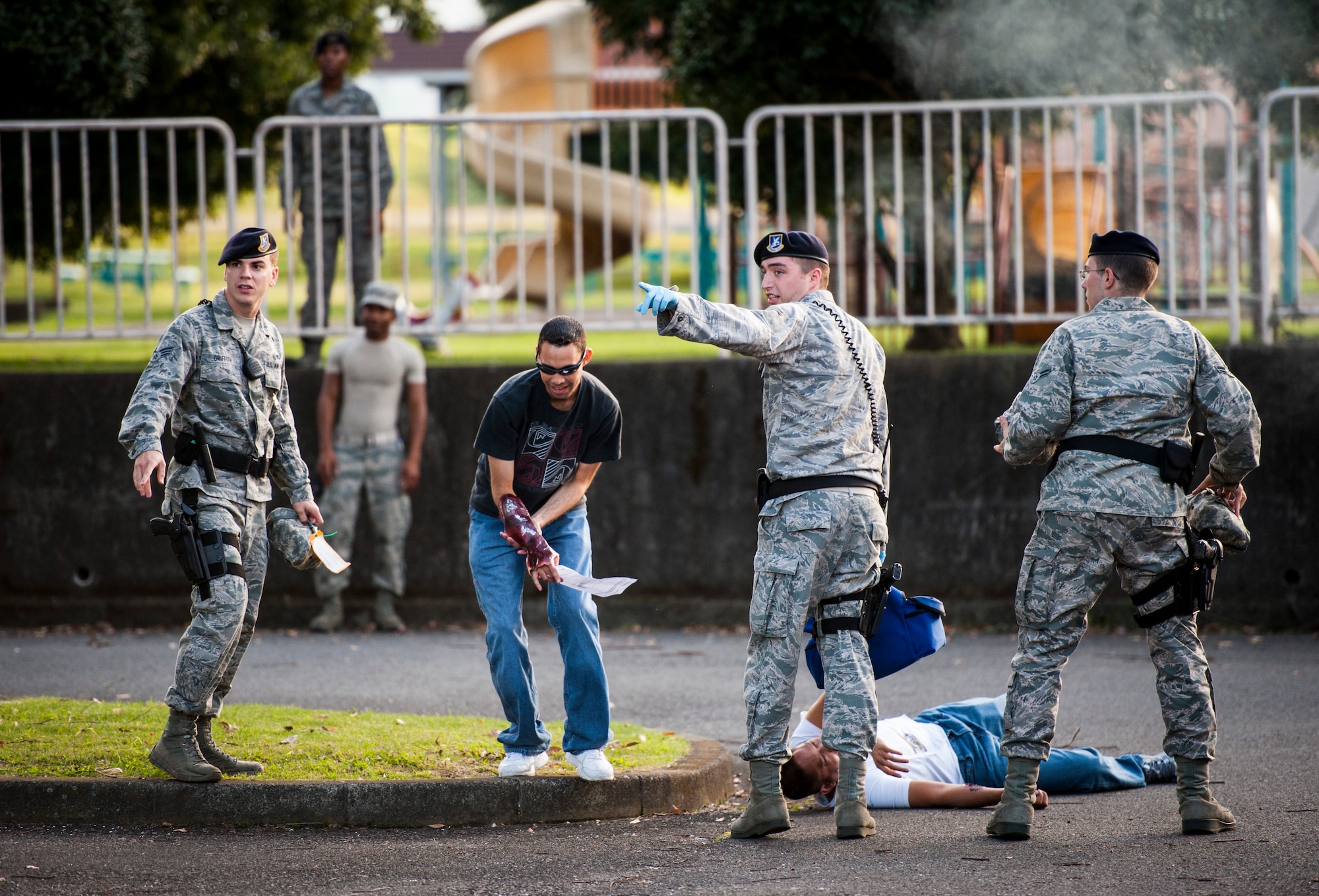 YOKOTA AIR BASE, Japan -- First responders from the 374th Security Forces Squadron direct simulated victims to safety during an emergency management exercise at Yokota Air Base, Japan, Oct. 5, 2012. Many of the role players had moulage applied to simulate injuries of varying degrees. (U.S. Air Force photo by Tech. Sgt. Samuel Morse)