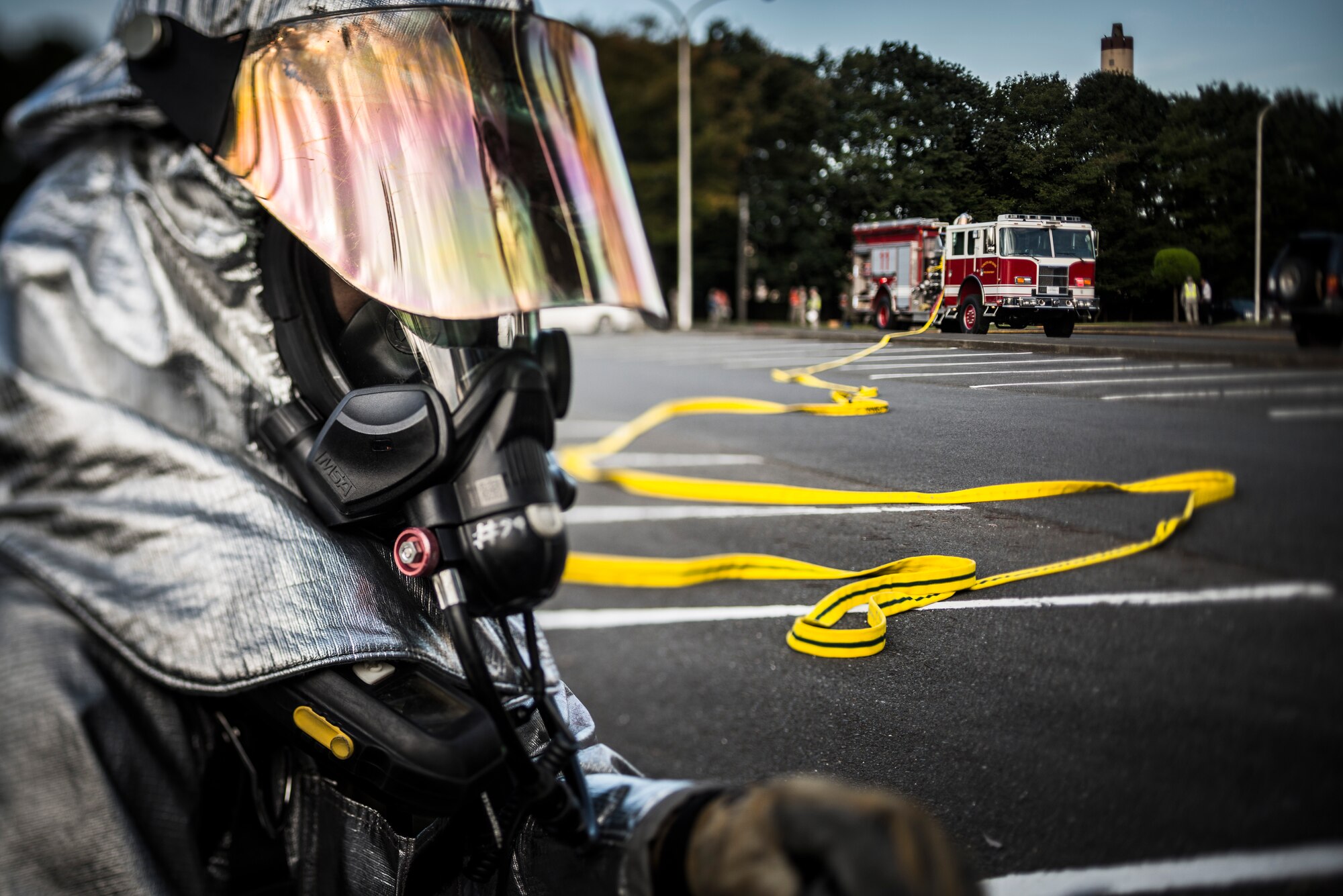 YOKOTA AIR BASE, Japan -- A firefighter from the 374th Civil Engineer Squadron pauses after responding to a simulated bus fire during an emergency management exercise at Yokota Air Base, Japan, Oct. 5, 2012. The one-hour exercise gave emergency crews a chance to practice working together to save lives. (U.S. Air Force photo by Tech. Sgt. Samuel Morse)