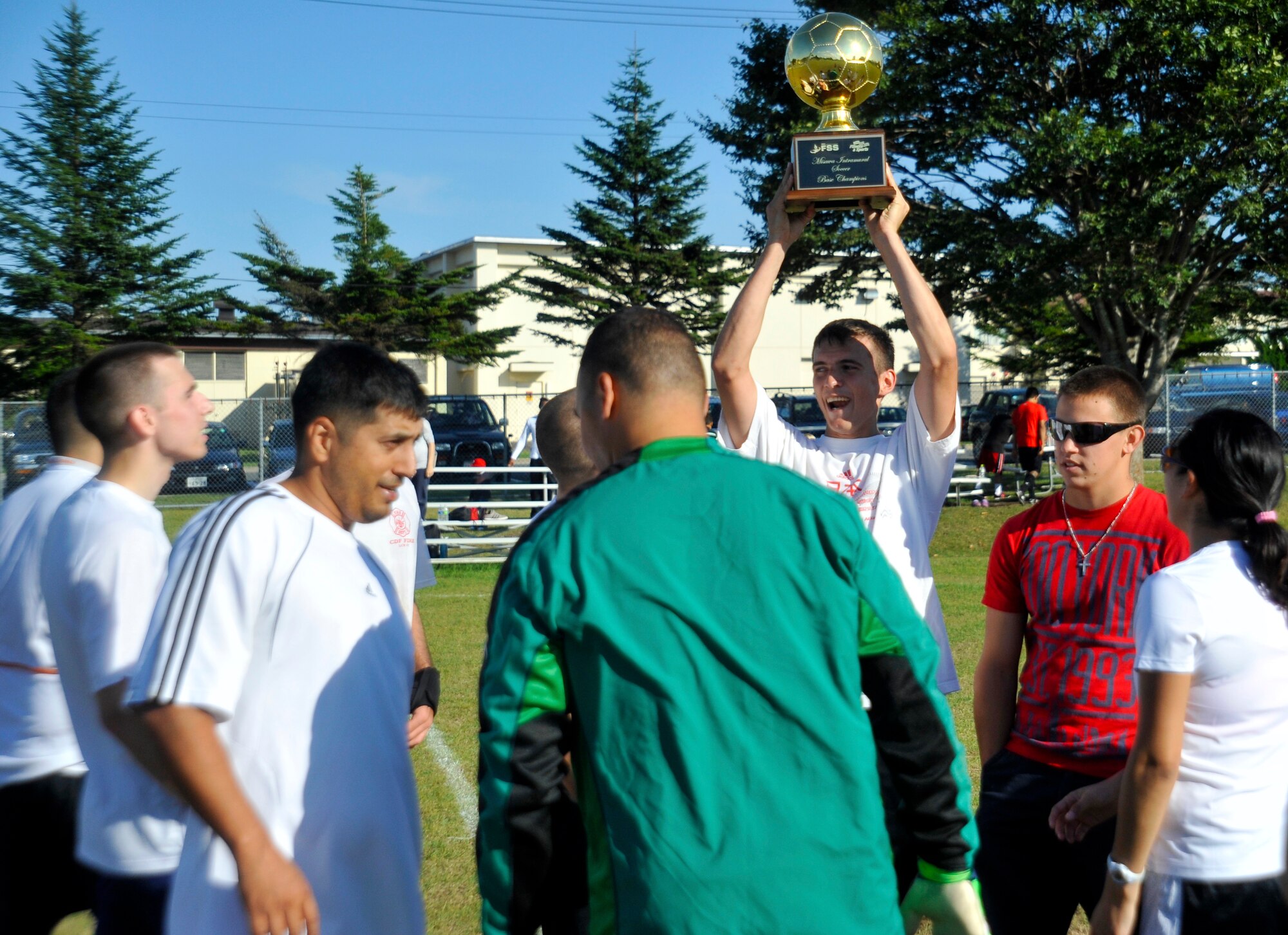 Members of the 35th Logistics Readiness Squadron soccer team celebrate after receiving the trophy for the intramural soccer championship at Misawa Air Base, Japan, Oct. 7, 2012. The 35 LRS defeated the 35th Aircraft Maintenance Squadron two to one to win the championship. (U.S. Air Force photo by Airman 1st Class Zachary Kee)