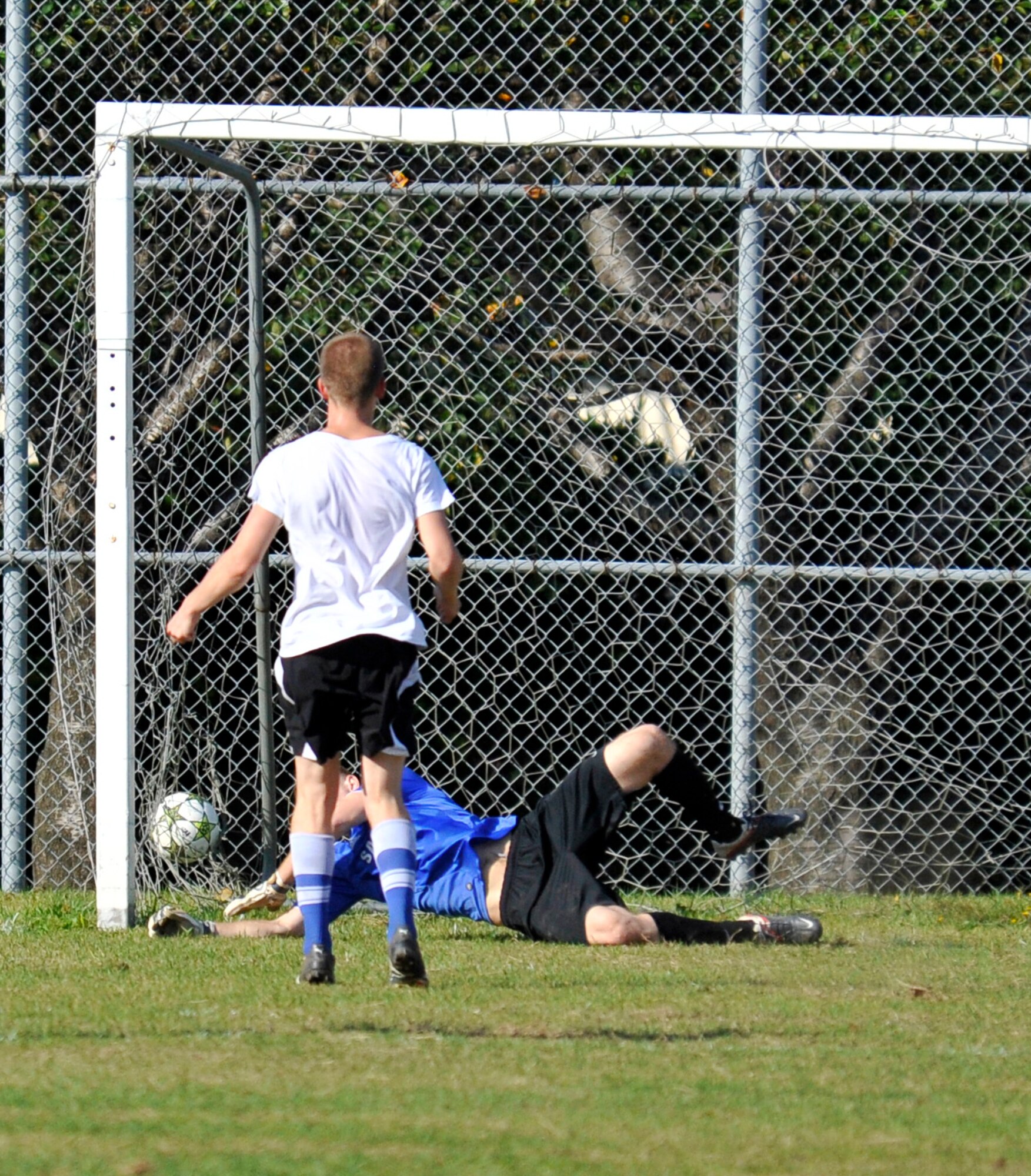 Jeffrey Catton, 35th Logistics Readiness Squadron soccer team member, scores on a penalty kick to give his team the victory in the intramural soccer championship at Misawa Air Base, Japan, Oct. 7, 2012. Catton was given the opportunity after a hand ball was called inside the box with two minutes remaining in the game. The final score was 35 LRS two and the 35th Aircraft Maintenance Squadron one. (U.S. Air Force photo by Airman 1st Class Zachary Kee)