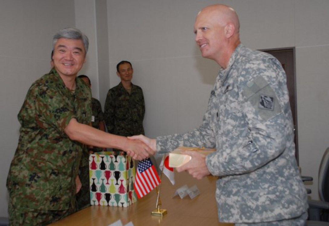 Lt. Col. James C. Horton Jr. presents a gift to Japan Ground Self-Defense Force Maj. Gen. Masafumi Akamatsu, commandant of the JGSDF's Engineer School, during a visit to Camp Katsuta in Ibaraki Prefecture.