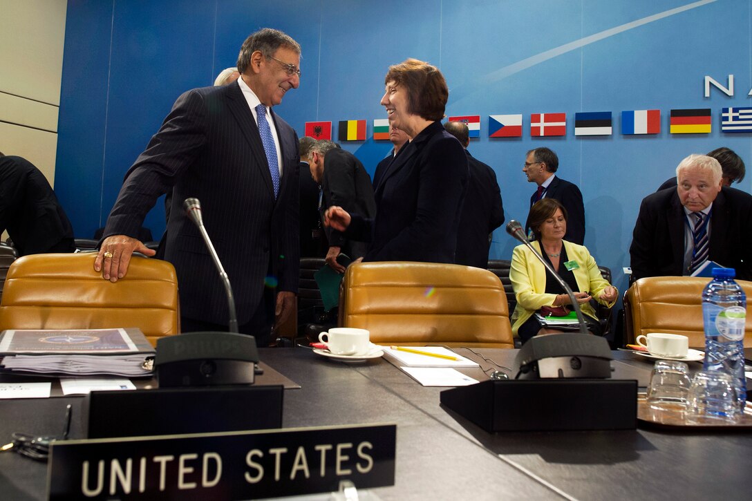 U.S. Defense Secretary Leon E. Panetta, left, speaks with Catherine Ashton, right, European Union high representative for foreign affairs and security policy, at the beginning of a meeting of NATO defense ministers and members of the North Atlantic Council in Brussels, Oct. 9, 2012. 