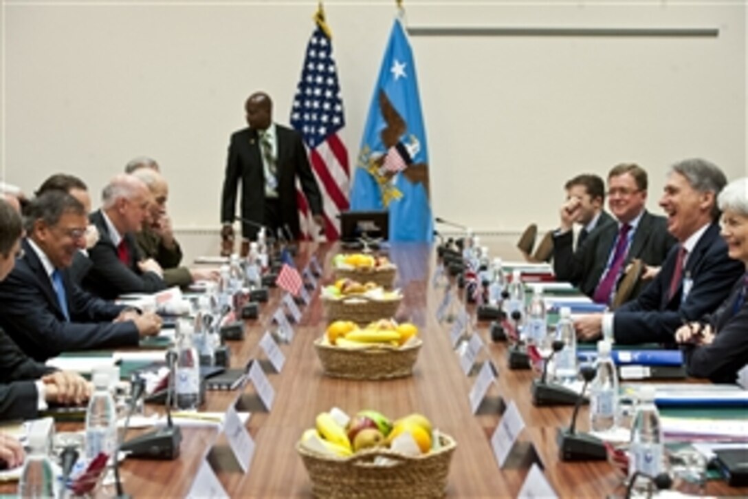 U.S. Defense Secretary Leon E. Panetta, left, meets with British Defense Secretary Philip Hammond, right, before the first meetings of the NATO defense ministers and members of the North Atlantic Council in Brussels, Oct. 9, 2012. 