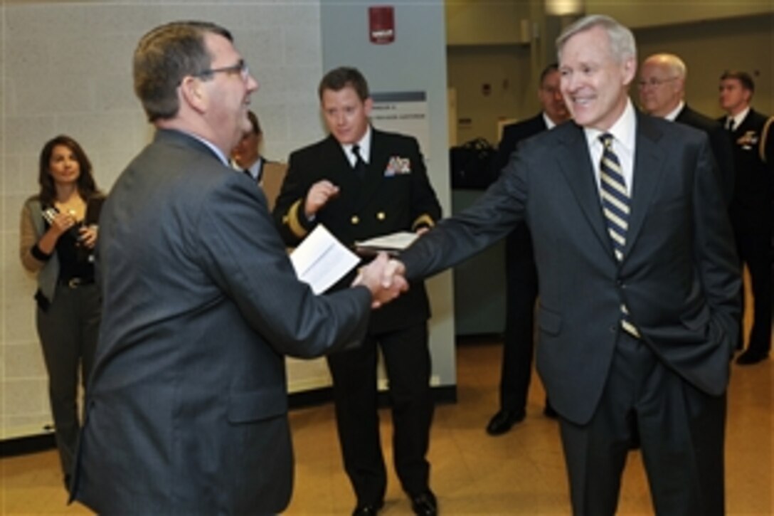 Navy Secretary Ray Mabus, right, greets Deputy Defense Secretary Ashton B. Carter as he arrives for the Navy's birthday celebration at the Pentagon, Oct. 9, 2012.