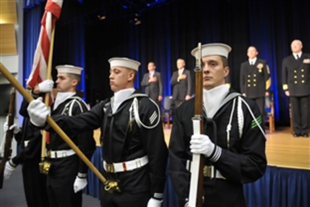 Deputy Defense Secretary Ashton B. Carter, back left, and Navy Secretary Ray Mabus observe the presentation of colors during the Navy's 237th birthday celebration at the Pentagon, Oct. 9, 2012.