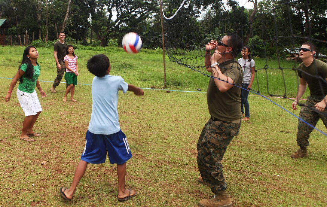Marines and Sailors play volleyball with Filipino elementary school children during a community relations visit here, Oct. 7. One of four COMREL visits scheduled during the MEU's Amphibious Landing Exercise throughout the Philippines, Marines and Sailors visit multiple elementary schools in Puerto Princesa City to play with the children before rendering medical and dental care and engineering assistance. PHIBLEX, now in its 29th iteration, is an annually-scheduled exercise between the U.S. and Philippine forces, aimed at strengthening military-to-military interoperability and bilateral relationships.