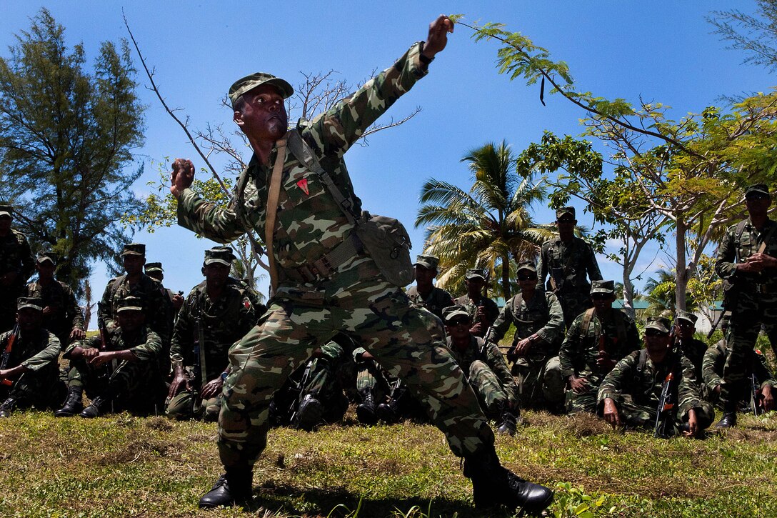 GAN, Republic of Maldives - A rifleman with Marine Deployment Unit 5, Maldivian National Defense Force, demonstrates throwing a grenade during a fragmentation battle station here Oct. 6 as part of Exercise Coconut Grove 2012, being conducted Oct. 6-17. Coconut Grove is a bilateral training exercise conducted bi-annually between the U.S. Marine Corps and the MNDF.