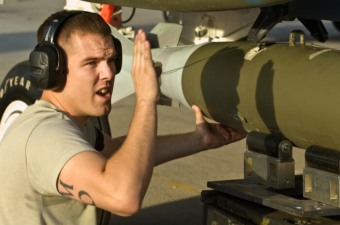 U.S. Air Force Staff Sgt. Christopher Simison, 757th Aircraft Maintenance Squadron Strike Aircraft Maintenance Unit weapons load crew team chief, loads a MK-82 general purpose bomb onto an F-15 Strike Eagle during a quarterly load crew competition, Oct. 5, 2012, at Nellis Air Force Base, Nev. Airmen that compete are chosen by their section chiefs based on job performance. (U.S. Air Force photo by Airman 1st Class Matthew Lancaster)