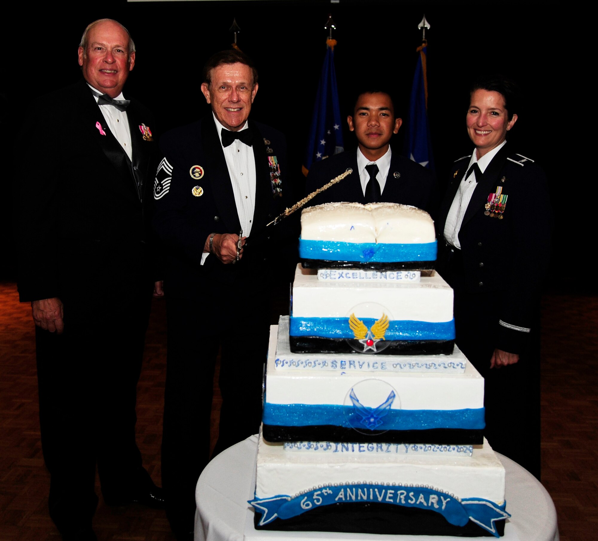 VANDENBERG AIR FORCE BASE, Calif. – Retired Chief Master Sgt. Norm Marous, Joint Retired Members Center director, and Airman Basic Ferdie Galicia, 532nd Training Squadron student, poseswith the Air Force Ball guest speaker retired Gen. Lance W. Lord, former Air Force Space Command commander, and Col. Nina Armagno, 30th Space Wing commander, for a photo after the ceremonial cutting of the birthday cake during the Air Force Ball here Friday, Oct. 5, 2012. (U.S. Air Force photo/Senior Airman Lael Huss)