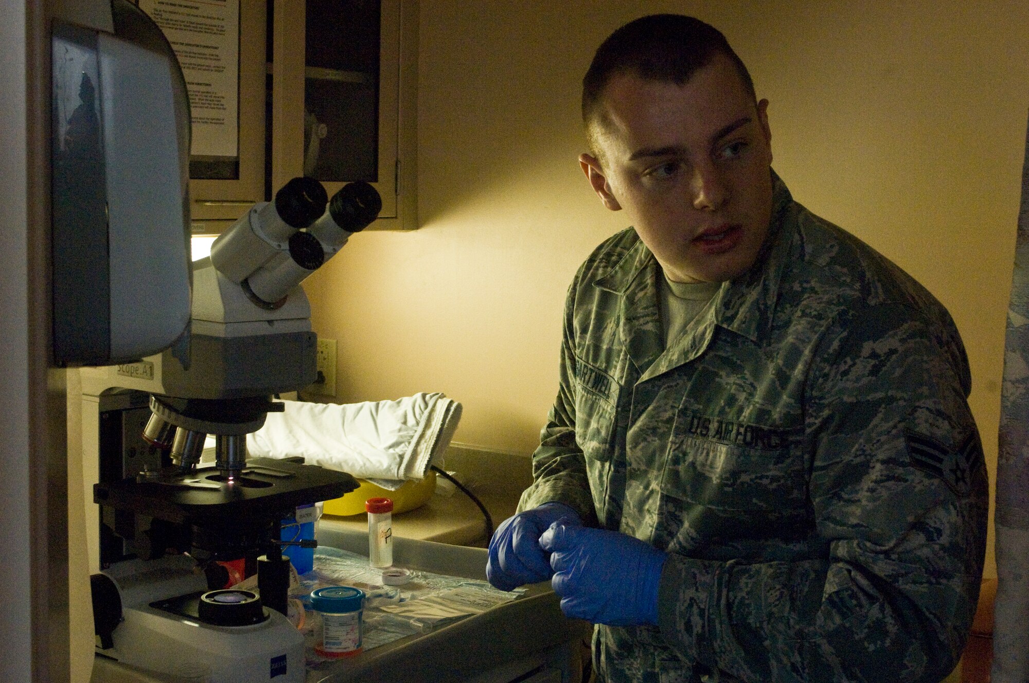 Senior Airman Thomas Sartwell, 99th Medical Operations Squadron histology technician, reviews material removed by a Endobronchial Ultrasound Broncialscope procedure performed moments earlier Oct. 4, 2012, at Nellis Air Force Base Nev. The Endobronchial Ultrasound Bronchialscope procedure is a newer procedure for the Mike O?Callaghan Federal Medical Center. The procedure is less invasive than traditional surgery and can provide quicker results to patients as well as being more cost efficient. (U.S. Air Force photo by Senior Airman Jack Sanders)
