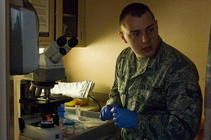 Senior Airman Thomas Sartwell, 99th Medical Operations Squadron histology technician, reviews material removed by a Endobronchial Ultrasound Broncialscope procedure performed moments earlier Oct. 4, 2012, at Nellis Air Force Base Nev. The Endobronchial Ultrasound Bronchialscope procedure is a newer procedure for the Mike O?Callaghan Federal Medical Center. The procedure is less invasive than traditional surgery and can provide quicker results to patients as well as being more cost efficient. (U.S. Air Force photo by Senior Airman Jack Sanders)