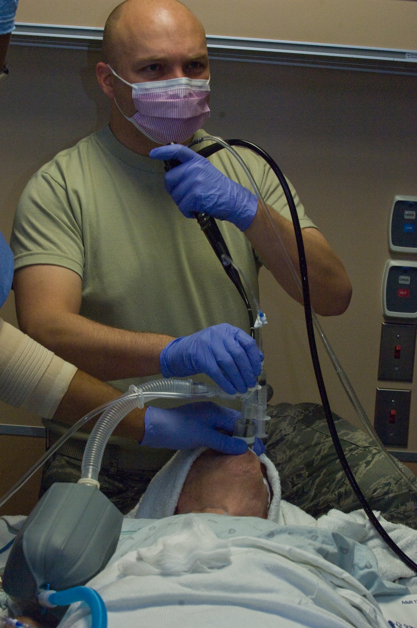 Maj. Jeremy Kilburn, 99th Medical Operations Squadron cardiopulmonary flight commander and Intensive Care Unit director, stares at a monitor showing the Bronchialscope as it moves through the patient?s lungs Oct. 4, 2012, at Nellis Air Force Base, Nev. The Endobronchial Ultrasound Bronchialscope procedure is a newer procedure for the Mike O?Calaghan Federal Medical Center. The procedure is less invasive than traditional surgery and can provide quicker results to patients as well as being more cost efficient. (U.S. Air Force photo by Senior Airman Jack Sanders)
