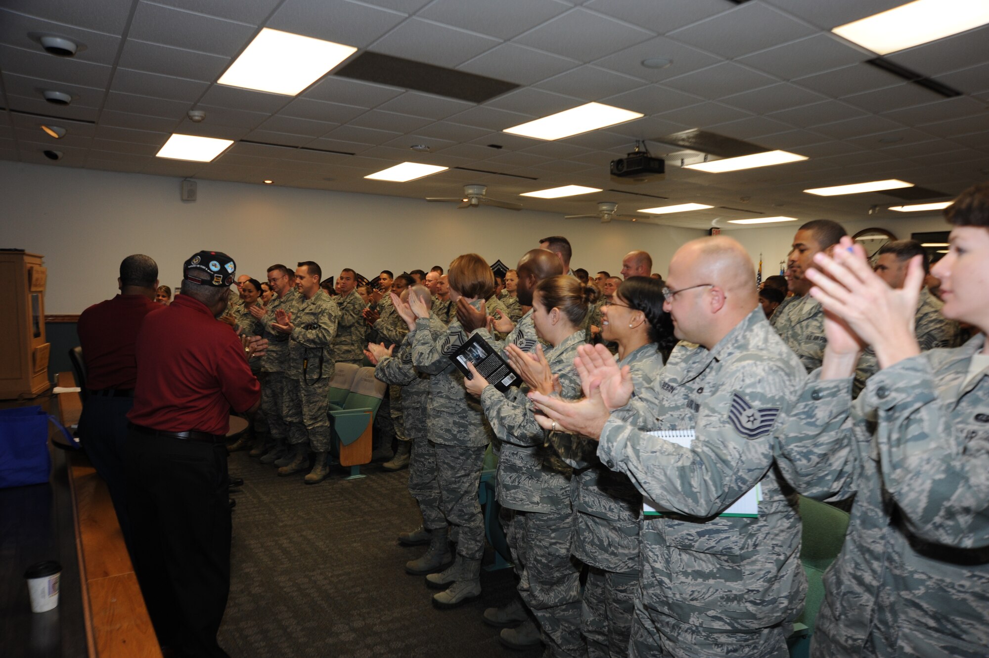 Students and instructors stand and applaud retired Chief Master Sgt. Walter Richardson after he shares the story of his career Oct. 4, 2012 at the Mathies NCO Academy. Richardson, a Tuskegee Airman with 332 Fighter Wing, was one of 1,500 African-American Airmen selected to being racial integration in the Air Force in 1949.  (U.S. Air Force photo by Staff Sgt. Eric Summers)