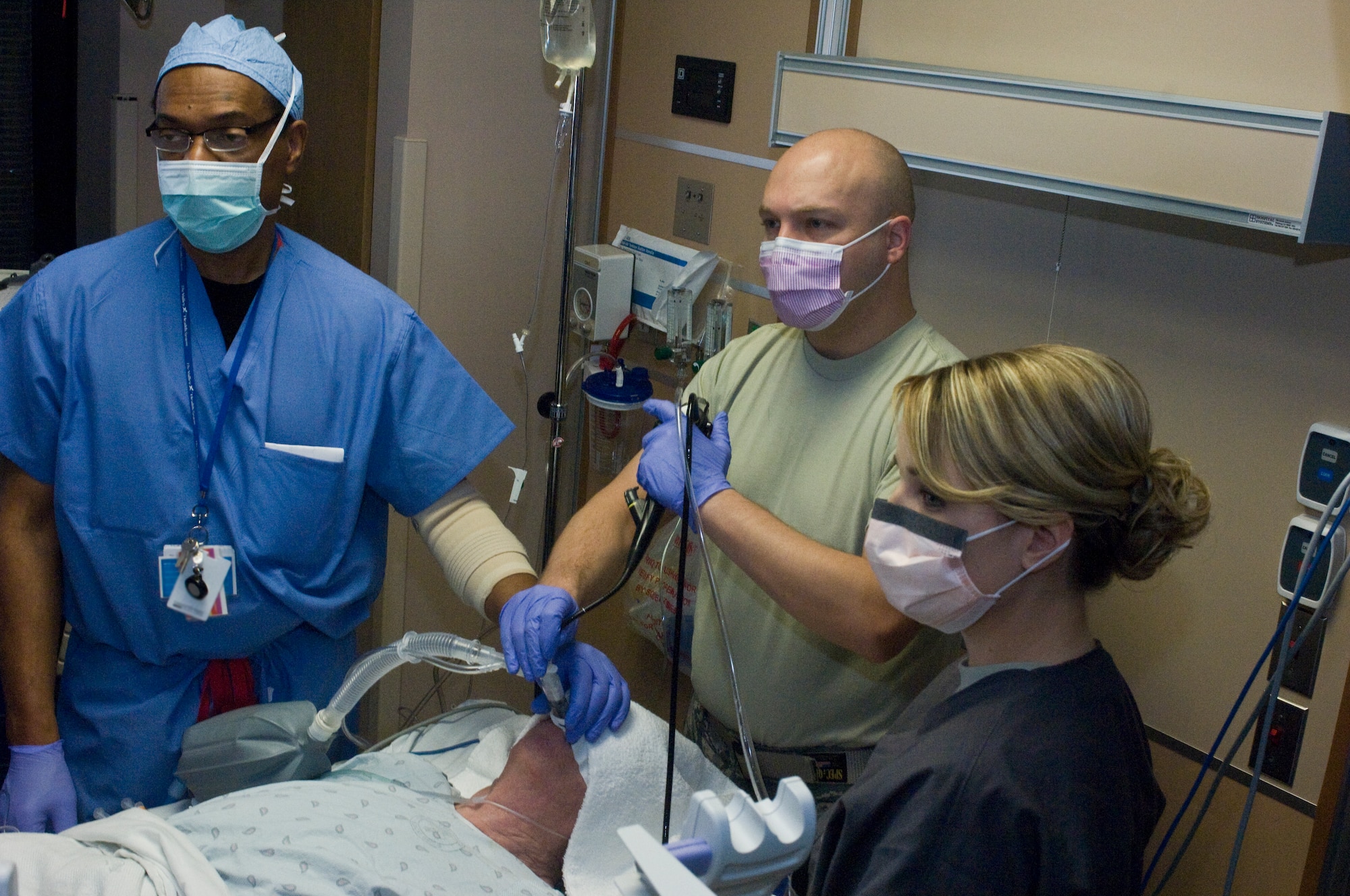 Maj.(Dr.) Jeremy Kilburn, 99th Medical Operations Squadron Cardiopulmonary Flight commander and Intensive Care Unit director, and the attending staff stare at a monitor showing the Endobronchial Ultrasound Broncialscope as it moves through the patient?s lungs Oct. 4, 2012, at Nellis Air Force Base, Nev. The Endobronchial Ultrasound Bronchialscope procedure is a newer procedure for the Mike O?Callaghan Federal Medical Center. The procedure is less invasive than traditional surgery and can provide quicker results to patients as well as being more cost efficient. (U.S. Air Force photo by Senior Airman Jack Sanders)