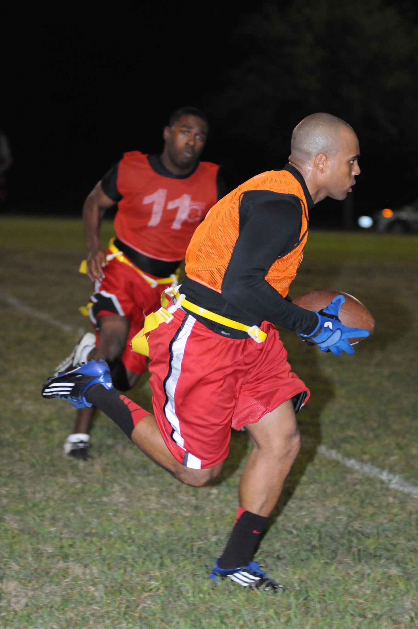 Sterling Wynn, 81st Security Forces Squadron, makes a run toward the end zone as Steven Gladney, 81st Training Support Squadron, closes in for the flag during an intramural flag football game Oct.  4, 2012, at Keesler Air Force Base, Miss.  The 81st SFS defeated the 81st TRSS, 21-7.  (U.S. Air Force photo by Kemberly Groue)