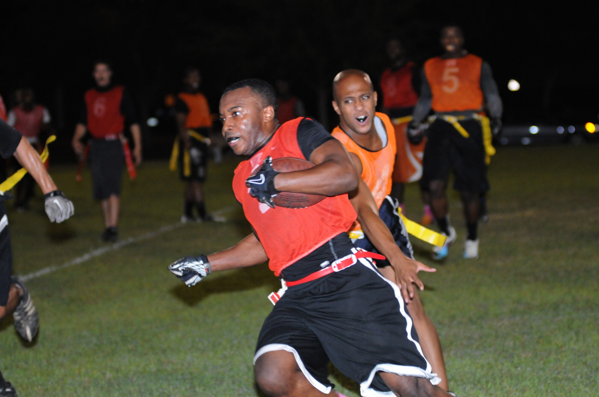 Travon Dowell, 81st Training Support Squadron, makes a run toward the end zone with Angelo Banks, 81st Security Forces Squadron, close behind during an intramural flag football game Oct. 4, 2012, at Keesler Air Force Base, Miss.  The 81st SFS defeated the 81st TRSS, 21-7.  (U.S. Air Force photo by Kemberly Groue)