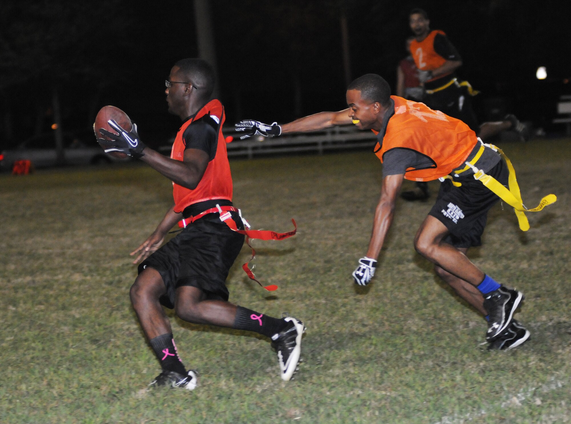 McKenzie Jackson, 81st Training Support Squadron, runs the ball as Lawrence Huff, 81st Security Forces Squadron, reaches for his flag during an intramural flag football game Oct. 4, 2012, at Keesler Air Force Base, Miss.  The 81st SFS defeated the 81st TRSS, 21-7.  (U.S. Air Force photo by Kemberly Groue)
