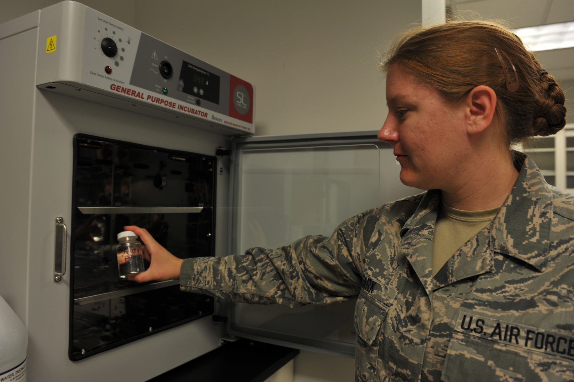 Staff Sgt. Aimee Stark, 509th Medical Operations Squadron Bioenvironmental Engineer, places media mix into incubator Oct. 3, 2012 at Whiteman Air Force Base, Mo. Bioenvironmental Engineers test for the absence of coliform bacterial or E-Coli. (U.S. Air Force photo/Heidi Hunt) (Released)