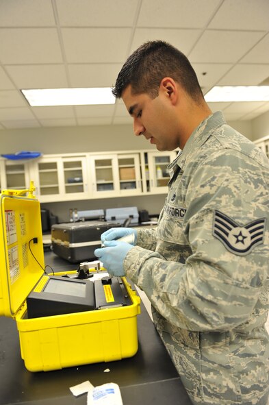 Staff Sgt. Edwin Origel, 509th Medical Operations Squadron Bioenvironmental Engineer, uses a HazMatID to tests for unknown substances at Whiteman Air Force Base, Mo., Oct. 3, 2012. The HazMatID device is used to identify any powder or liquid substance and can be transported to any location to perform the test. (U.S. Air Force photo/Heidi Hunt) (Released)