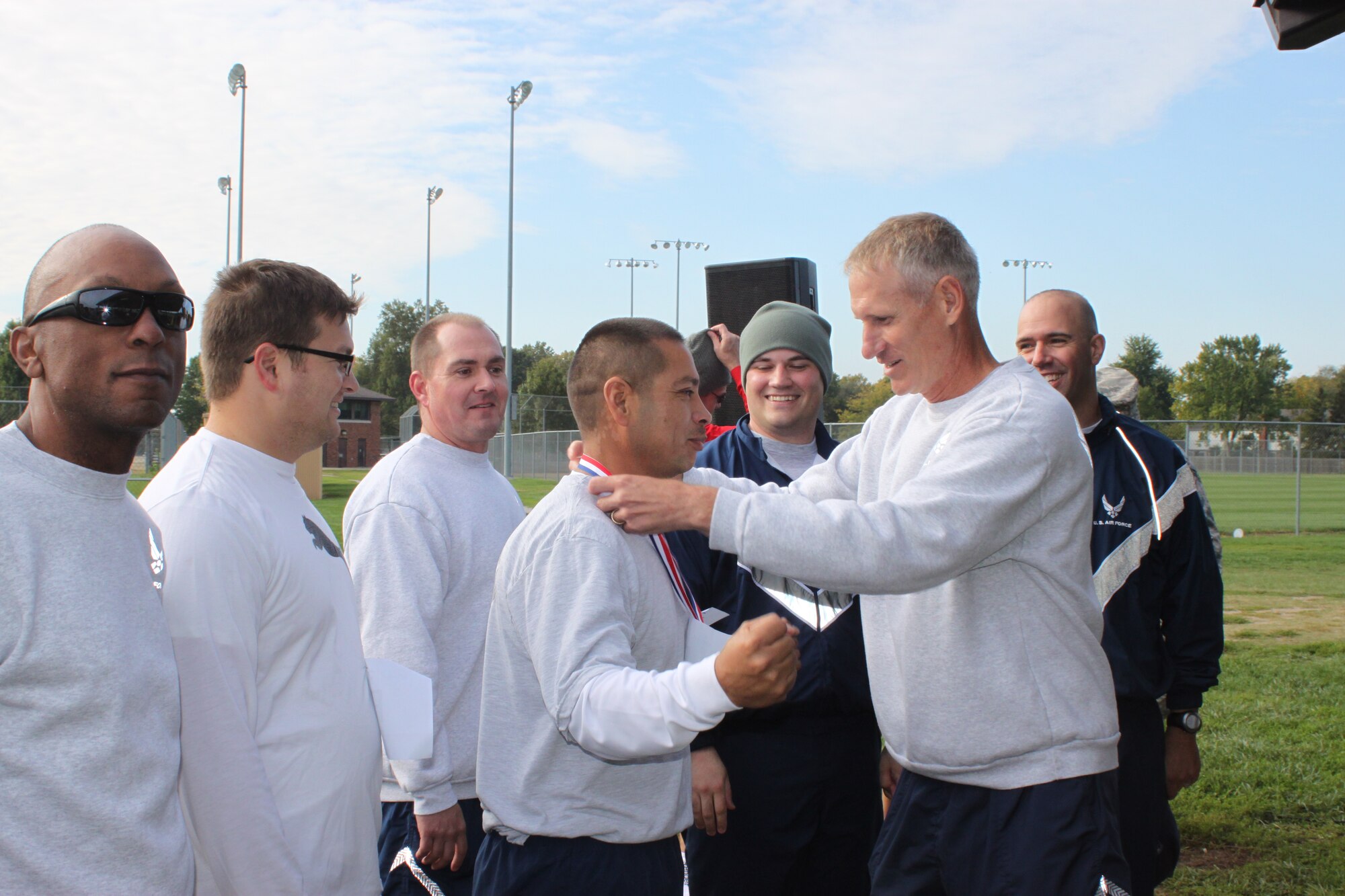 Race participants receive a trophy from Col. David Almand, 375th Air Mobility Wing commander after completing the 6.5 miles in the first Michael Maybin Relay Oct. 2, 2012. More than 100 members participated. (U.S. Air Force photo/Staff Sergeant Stephenie Wade)