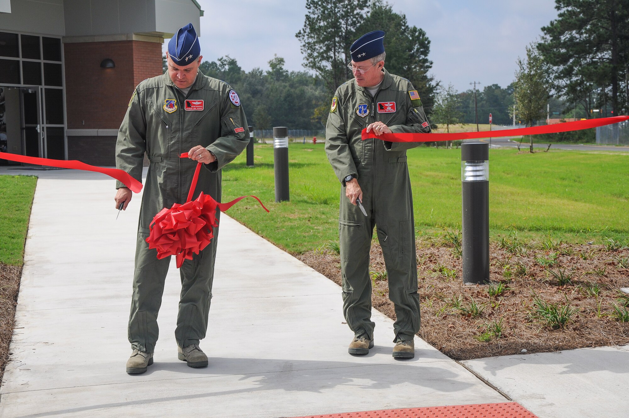 National Guard Maj. Gen. Jim Butterworth, Adjutant General of Georgia, and National Guard Maj. Gen. Thomas Moore, Georgia Air National Guard Commander, cut the ceremonial ribbon dedicating the 165th Air Support Operations Squadron's new building, Oct, 10, 2012 at Savannah Air National Guard base in Garden City, Ga. The 165th ASOS relocated from Brunswick, Ga. to the new location in Garden City, Ga. (National Guard photo by Tech. Sgt. Charles Delano/released)