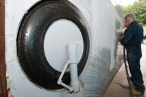 HANSCOM AIR FORCE BASE, Mass. – George Bennett prepares the P-40 wing for painting. Work continues to refurbish the static display aircraft. (U.S. Air Force photo by Rick Berry) 