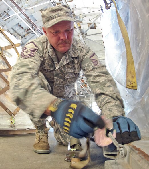 Air National Guard Master Sgt. Edward Chastain, 116th Traffic Management Flight (TMF), installs a cargo net on a pallet of equipment at Robins Air Force Base, Ga., June 27, 2012.  The 116th TMF prepared pallets of firefighting and rescue equipment for a humanitarian mission to Nicaragua. (National Guard photo by Master Sgt. Roger Parsons/Released)