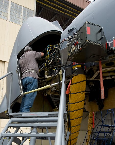 Tech. Sgt. Ken Woolley, 307th Aircraft Maintenance Squadron Active Reserve technician, connects cables under the nose cone of a B-52H Stratofortress while running an electronic countermeasures test on Barksdale Air Force Base, La., Oct. 10. The test, which takes several days to complete, ensures that all ECM components on the aircraft are working properly and can defend the plane if it were to be engaged by the enemy. (U.S. Air Force photo/Staff Sgt. Chad Warren)(RELEASED)