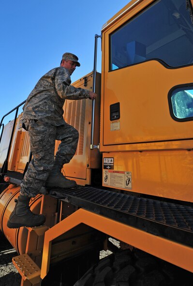 Col. Brian Newberry, 92nd Air Refueling Wing commander, enters a snow removal vehicle to drive during the annual snow parade at Fairchild Air Force Base, Wash., Oct. 4, 2012. Fairchild senior leadership inspected the readiness of the mission-critical equipment during the parade. (U.S. Air Force photo by Airman 1st Class Taylor Curry)