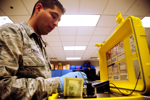 Staff Sgt. Edwin Origel, 509th Medical Operations Squadron bioenvironmental engineer, explains how a Hazmat ID works during training at Whiteman Air Force Base, Mo., Oct 3. The Hazmat ID is used to test suspicious liquids and powers for radiation. (U.S. Air Force photo/Senior Airman Cody H. Ramirez)(RELEASED)