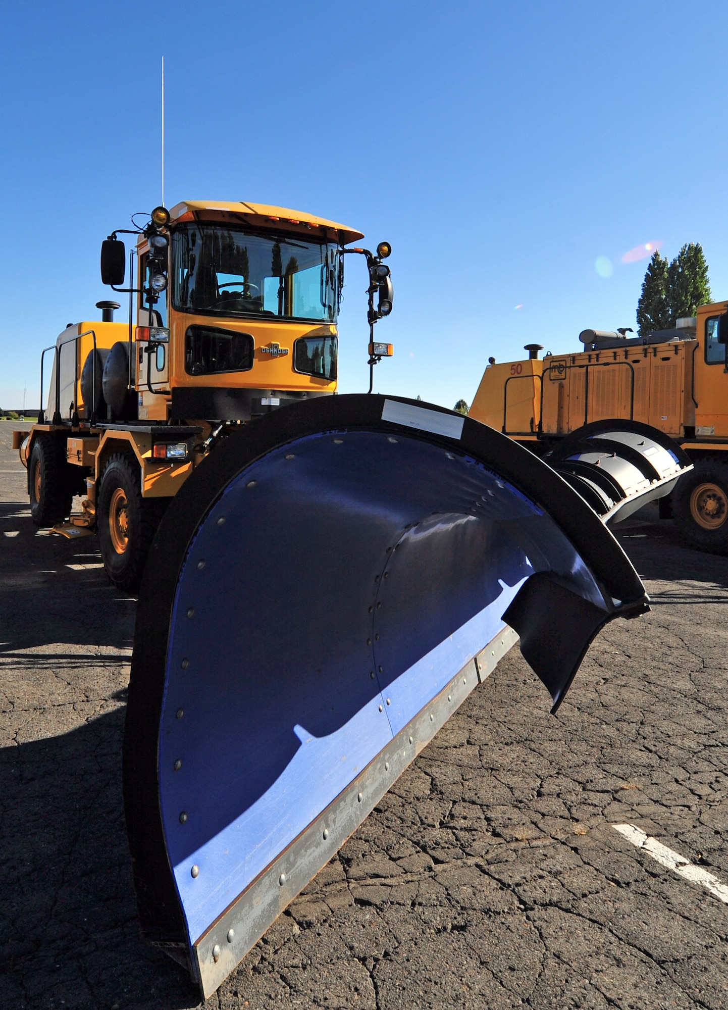 An airfield snow plow sits in line with other snow removal vehicles during the annual snow parade at Fairchild Air Force Base, Wash., Oct. 4, 2012. The snow removal team is responsible for snow and ice control across the entire runway, all aircraft parking areas and taxiways. They also remove snow from all streets and parking areas on base. (U.S. Air Force photo by Airman 1st Class Taylor Curry)