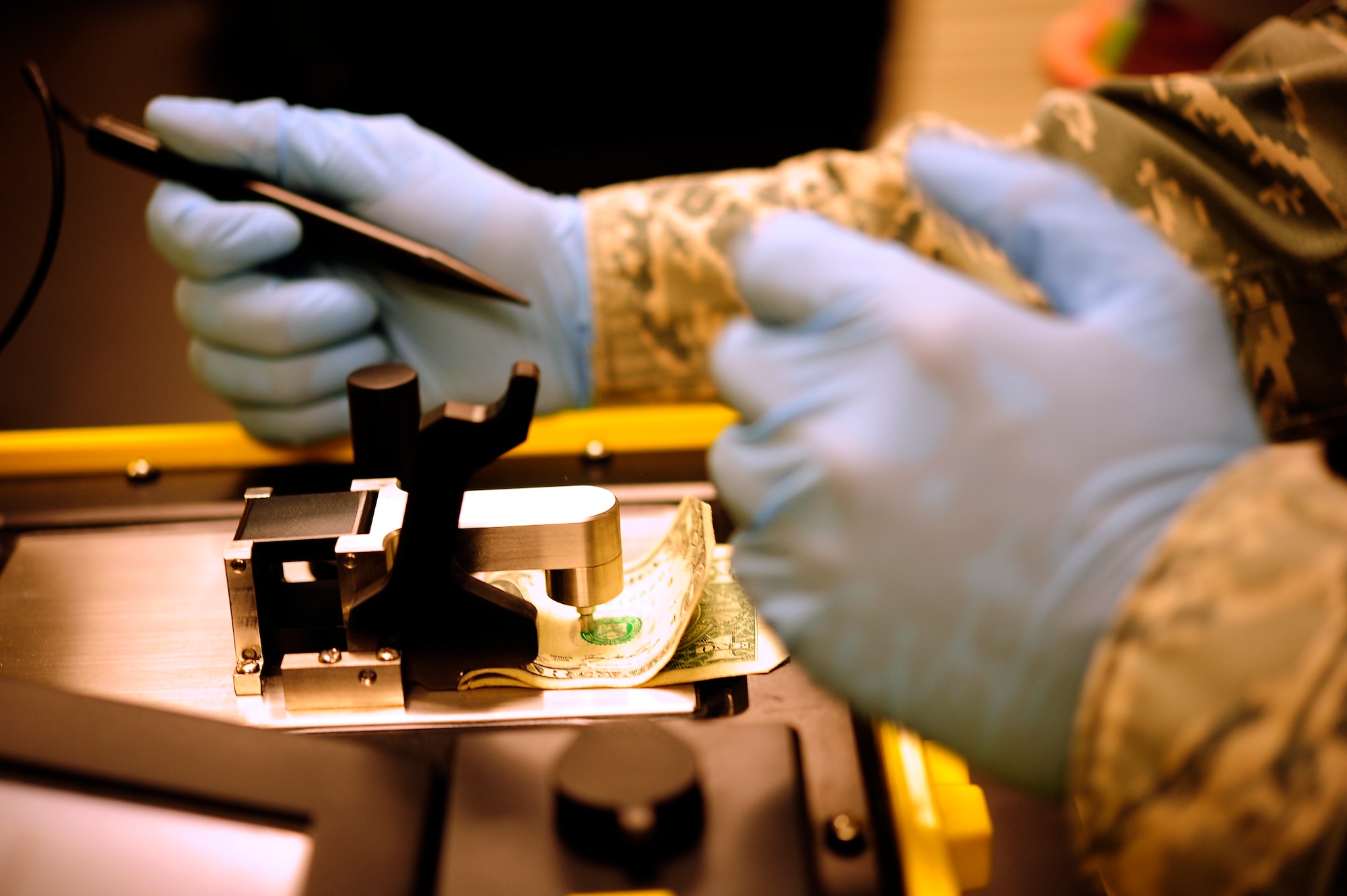 Staff Sgt. Edwin Origel, 509th Medical Operations Squadron bioenvironmental engineer, uses a Hazmat ID to see what materials are contained on a dollar bill at Whiteman Air Force Base, Mo., Oct. 3. The Hazmat ID is used to test suspicious powers or liquids for radiation.(U.S. Air Force photo/Senior Airman Cody H. Ramirez)(RELEASED)