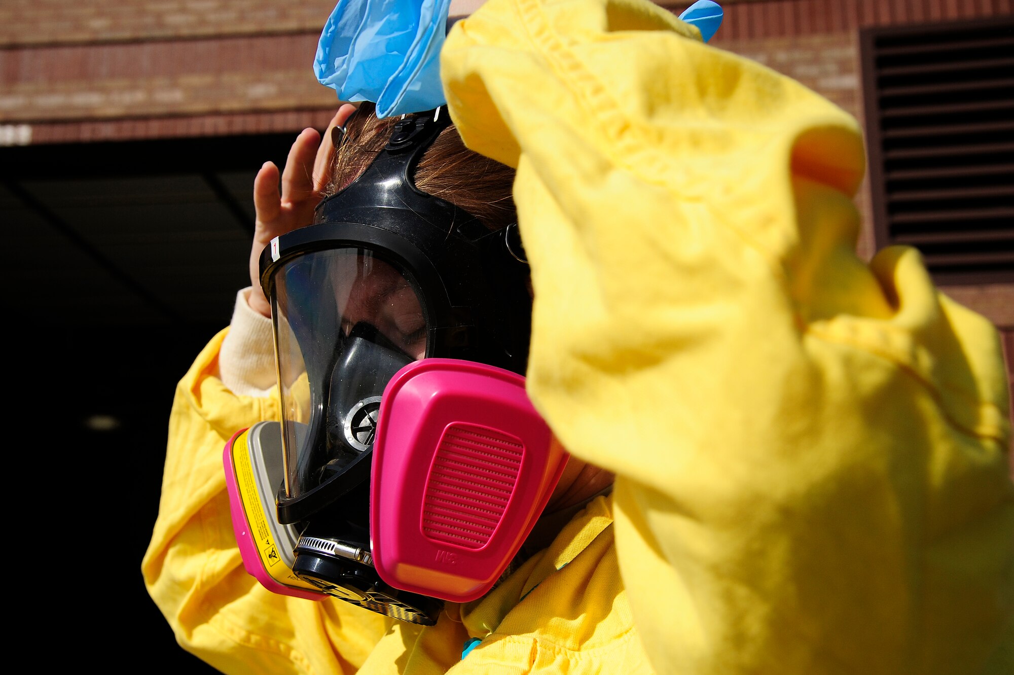 Staff Sgt. Aimee Stark, 509th Medical Operations Squadron bioenvironmental engineer, dawns a respirator and Anti-C Suit before practice testing for radiation at Whiteman Air Force Base, Mo., Oct. 3. The respirator and suit prevent the wearer from getting in contact with alpha and most beta rays which pose respiratory hazards. (U.S. Air Force photo/Senior Airman Cody H. Ramirez)(RELEASED)