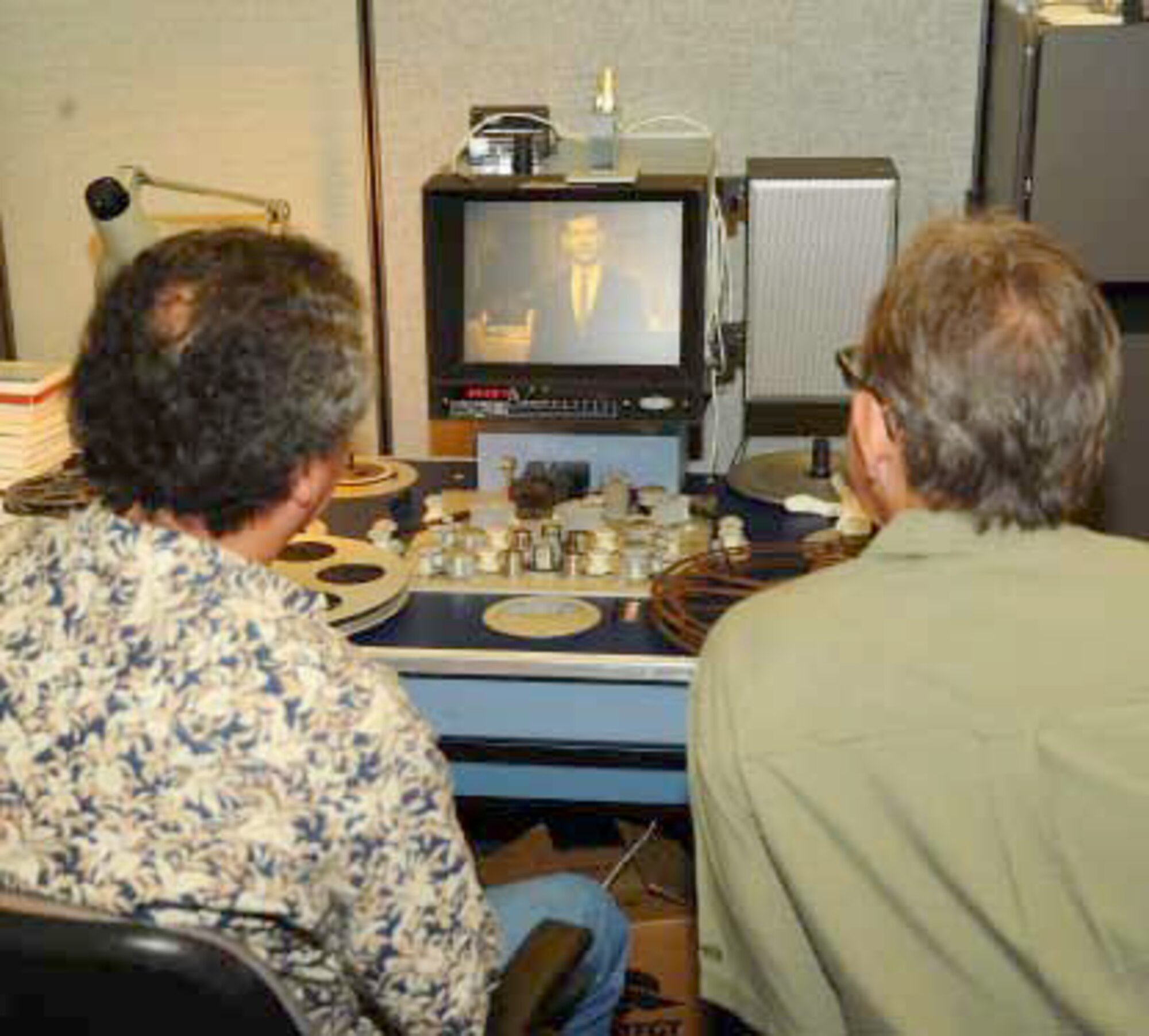 Pedro Loureiro, Ph.D. (left), Archivist at the Defense Imagery Management Operations Center (DIMOC) and Jeff Sotzing, Chief Executive Officer at Carson Entertainment Group, review a 1963 film of The Tonight Show Starring Johnny Carson that was once thought lost, but was found earlier this year. DIMOC turned over the film to Sotzing to be added to the Carson archives. (Department of Defense photo)
