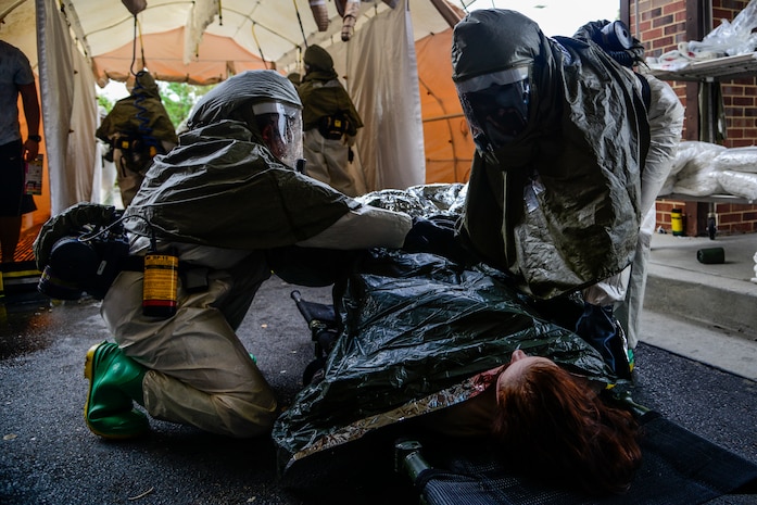 Airmen from the 628th Medical Group decontaminate a simulated casualty during a mass casualty exercise held Oct. 3, 2012 at Joint Base Charleston - Air Base, S.C. The exercise scenario simulated the explosion of a dirty bomb, a weapon that combines radioactive material with conventional explosives. The training prepares Airman to respond during a chemical, biological, radiological or nuclear catastrophe. (U.S. Air Force photo/Staff Sgt. Rasheen Douglas)