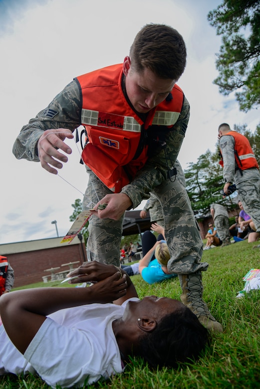 Senior Airman Nicholas Estrada, 628th Medical Group flight medicine technician, places a name tag on a victim while providing medical attention during a mass casualty exercise Oct. 3, 2012, at Joint Base Charleston - Air Base, S.C. The tags provide the victim’s medical information so medical technicians know what treatment is needed once the patient is relocated to a hospital. (U.S. Air Force photo/Staff Sgt. Rasheen Douglas)