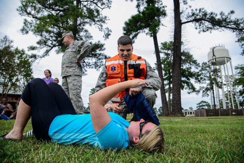Staff Sgt. John Becker, 628th Medical Group independent duty medical technician, provides medical attention to a victim during a mass casualty exercise Oct. 3, 2012, at Joint Base Charleston - Air Base, S.C. During the exercise, responders from the 628th MDG set up a cordon, secured the area and provided emergency medical treatment to simulated casualties. The training prepares Airmen to respond to a chemical, biological, radiological or nuclear catastrophe.  (U.S. Air Force photo/Staff Sgt. Rasheen Douglas)