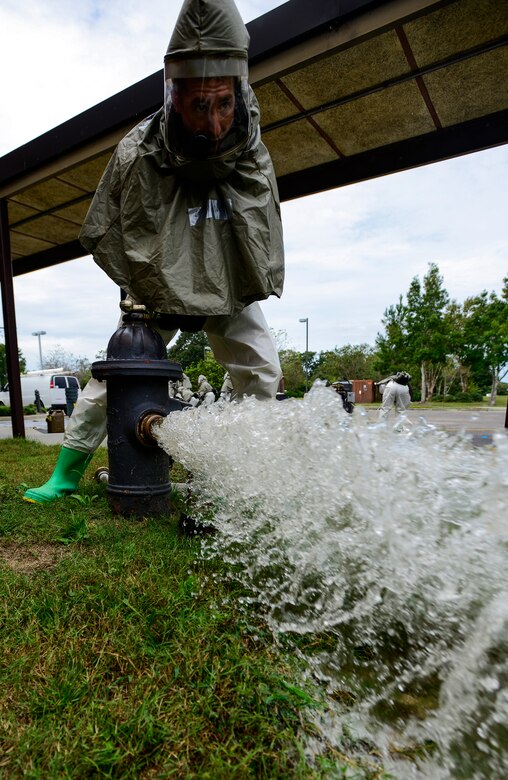 Staff Sgt. Louis Lough, 628th Aerospace Medicine Squadron, opens a fire hydrant before attaching a water hose to provide water to a decontamination tent during a mass casualty exercise Oct. 3, 2012, at Joint Base Charleston - Air Base, S.C. The training prepares Airmen to respond to a chemical, biological, radiological or nuclear attack. (U.S. Air Force photo/Staff Sgt. Rasheen Douglas)