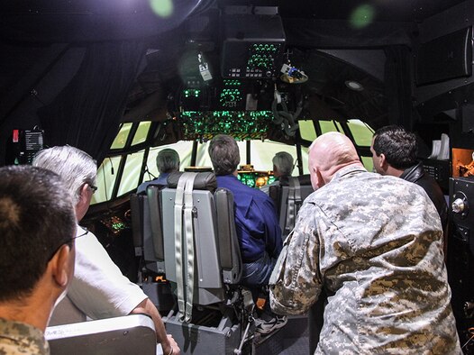 Civic Leaders from Pittsburgh operate the C-130 flight simulator at the Eastern Regional Flight Simulator Facility located at Dobbins Air Reserve Base, Ga., Oct. 3, 2012. Aviation simulators are used to train pilots in many aircraft operating procedures and have the advantage of being more cost effective to operate instead of flying an actual airplane. The system also allows pilots to train for any emergency procedures which cannot be practiced in the air. (U.S. Air Force photo by Tech. Sgt. Ralph Van Houtem/Released)