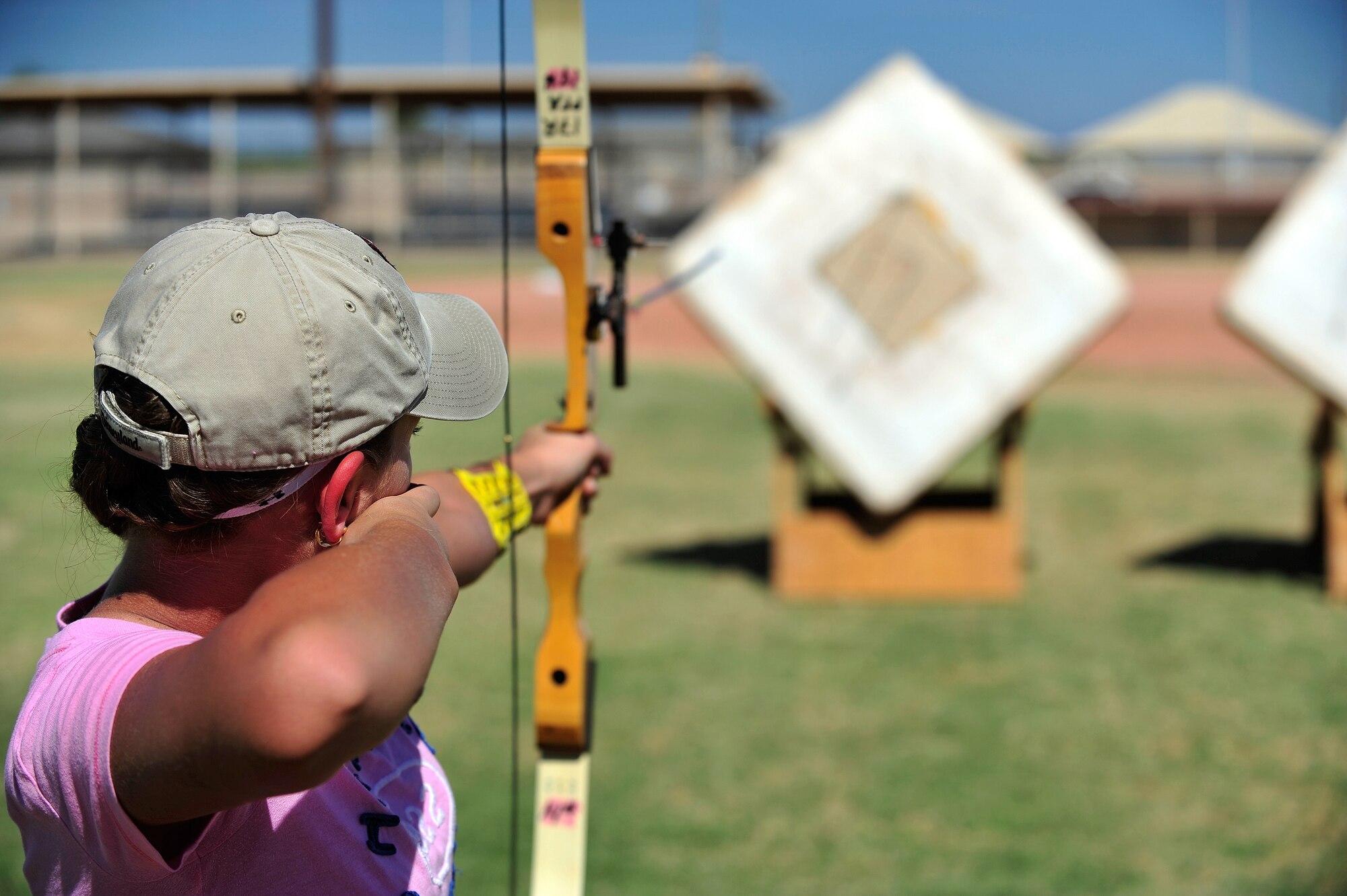 Alyssa Newman, 13, daughter of Lt. Col. Robyn Kramer, 56th Aerospace Medical Squadron Flight Surgeon, fires an arrow at a target during the youth and teen center archery camp at Luke Air Force Base, Ariz., Oct. 9, 2012. Newman was instructed on proper drawing technique, weapon care and different types of aiming techniques. (U.S. Air Force photo by Staff Sgt. Jason Colbert)