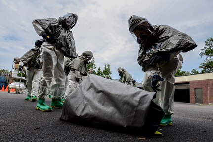 Airmen from the 628th Medical Group, unravel the floor of a decontamination tent during a mass casualty exercise Oct. 3, 2012, at Joint Base Charleston - Air Base, S.C. The training prepares Airmen to respond to a chemical, biological, radiological or nuclear attack. (U.S. Air Force photo/Staff Sgt. Rasheen Douglas)