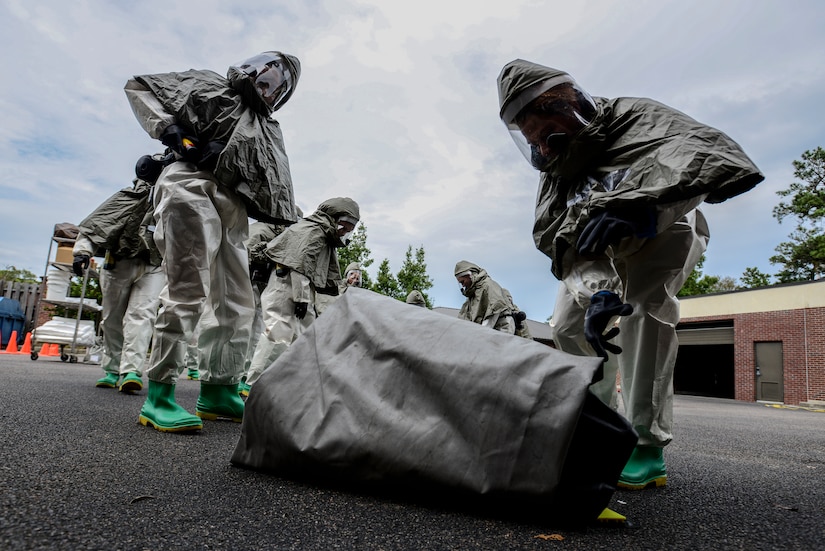 Airmen from the 628th Medical Group, unravel the floor of a decontamination tent during a mass casualty exercise Oct. 3, 2012, at Joint Base Charleston - Air Base, S.C. The training prepares Airmen to respond to a chemical, biological, radiological or nuclear attack. (U.S. Air Force photo/Staff Sgt. Rasheen Douglas)