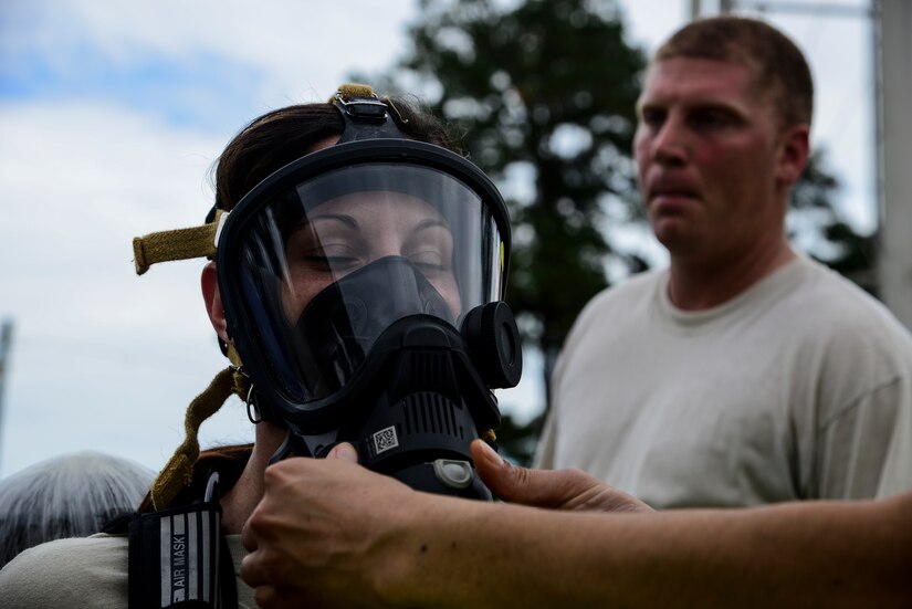 Staff Sgt. Jessica McFelia, 628th Civil Engineer Squadron bioenvironmental engineering technician, has her gas mask fitted before checking for hazardous chemicals and radiation following a simulated explosion during a mass casualty exercise Oct. 3, 2012, at Joint Base Charleston - Air Base, S.C. The training prepares Airmen to respond to a chemical, biological, radiological or nuclear catastrophe. (U.S. Air Force photo/Staff Sgt. Rasheen Douglas)
