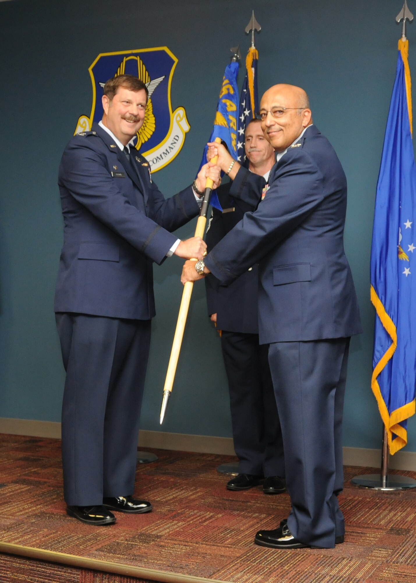 Col. Eduardo San Miguel (right) takes command of the 916th Aerospace Medicine Squadron during the September unit training assembly. Col. Greg Gilmour (left) presided over the ceremony in which Col. William Bobbitt relinquished command. (USAF photo by Tech. Sgt. Scotty Sweatt, 916ARW/PA)