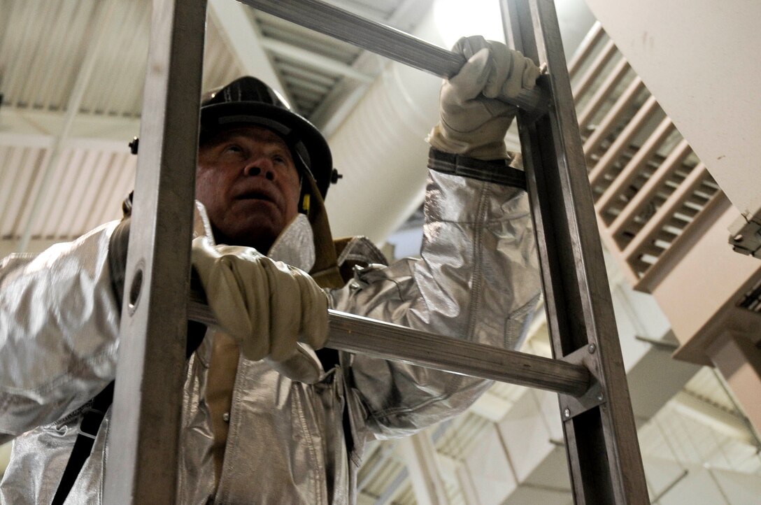 Kevin Vogel, 28th Civil Engineer Squadron real property officer, climbs a ladder during the Firefighter Challenge at the fire station at Ellsworth Air Force Base, S.D., Oct. 5, 2012. The event kicked off the annual Fire Prevention Week, which runs from Oct. 5 - 15, 2012, and includes an open house, a parade through base housing, and firefighters visiting area schools to talk about fire safety. (U.S. Air Force photo by Airman 1st Class Anania Tekurio/Released)